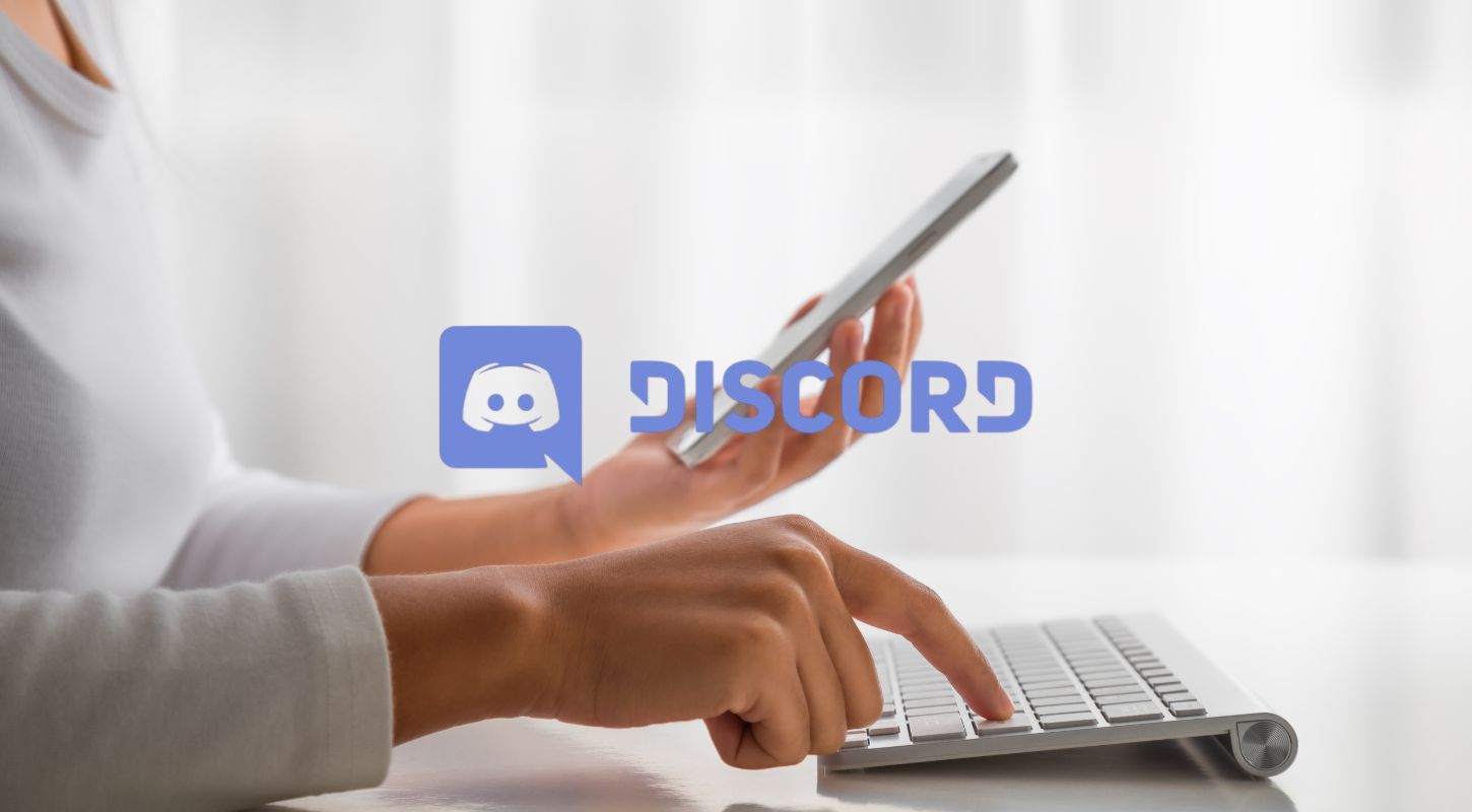 Person using a smartphone and laptop to bypass Discord phone number verification, related to Discord account verification and alternative methods.