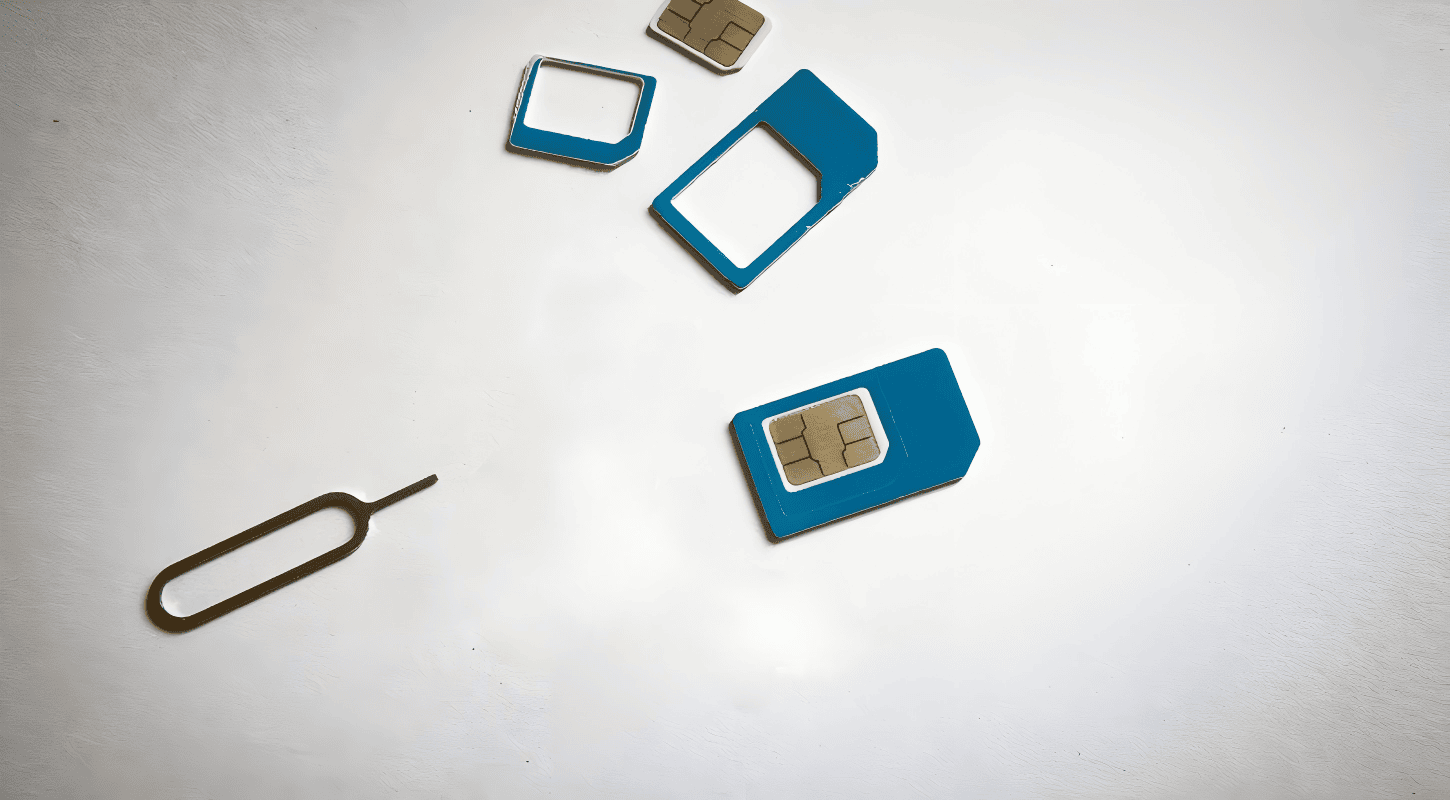 Image showing a SIM card, SIM card tray, and ejector tool used for locating and removing a SIM card to find its ICCID number.
