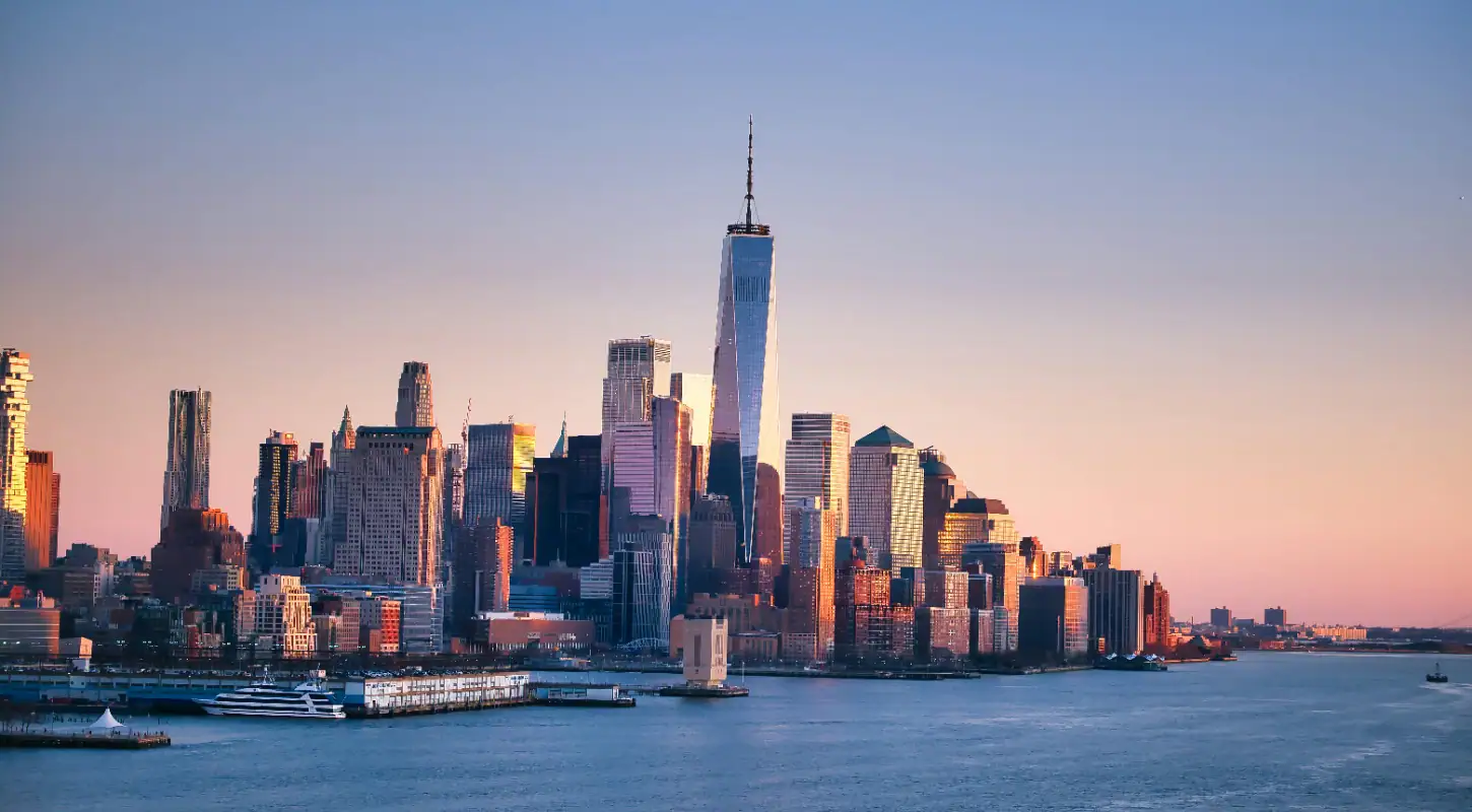 A panoramic view of New York City skyline featuring One World Trade Center and surrounding skyscrapers, highlighting major US area codes for phone numbers in 2026.
