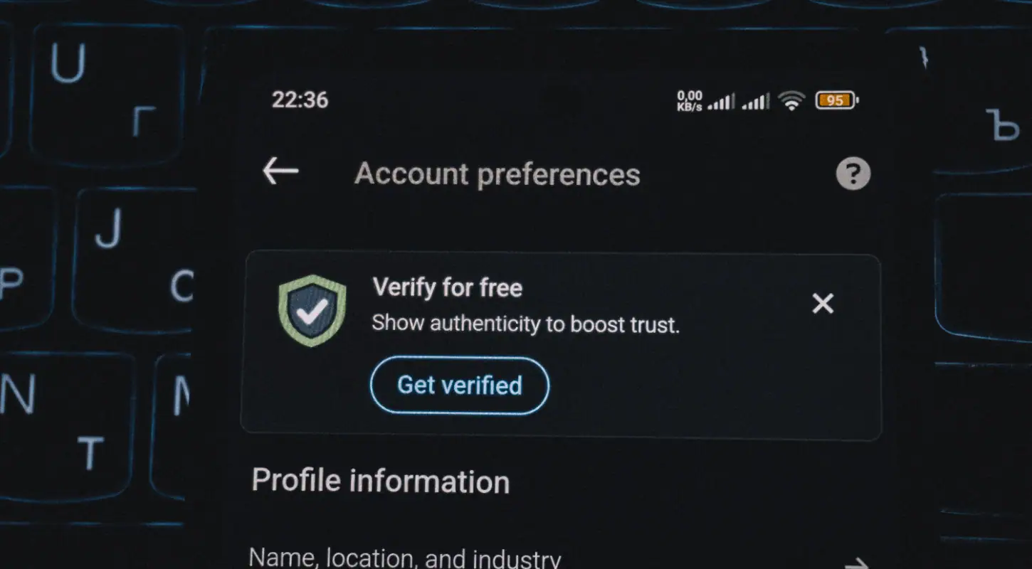 Mobile device screen showing 'Verify for free' option in account preferences for authentication verification.