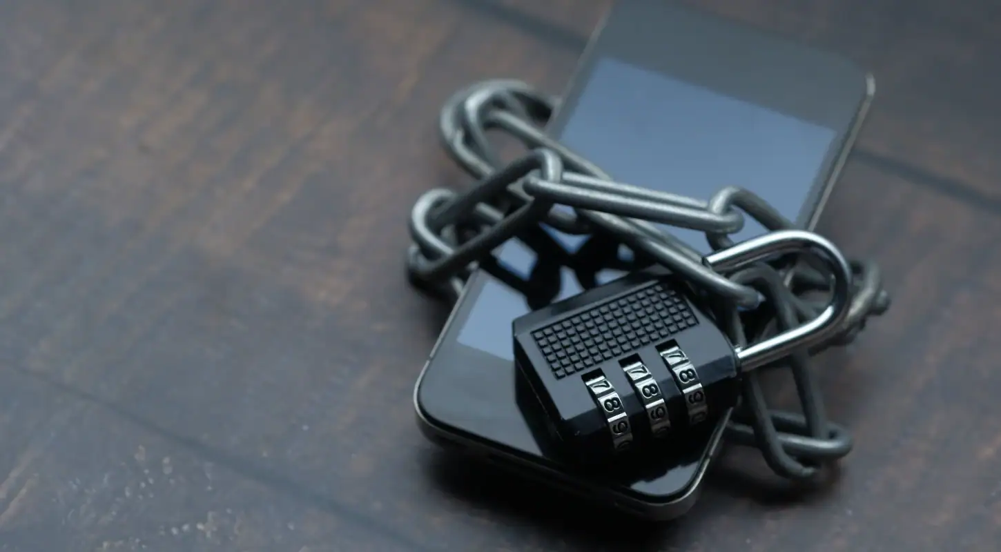 Smartphone secured with a chain and combination lock, symbolizing privacy protection and security for personal data.